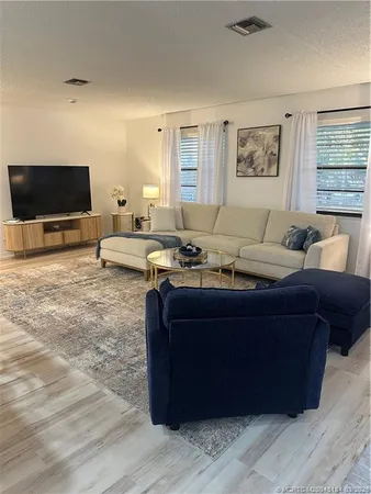 an aerial view of a house with a yard and lake view