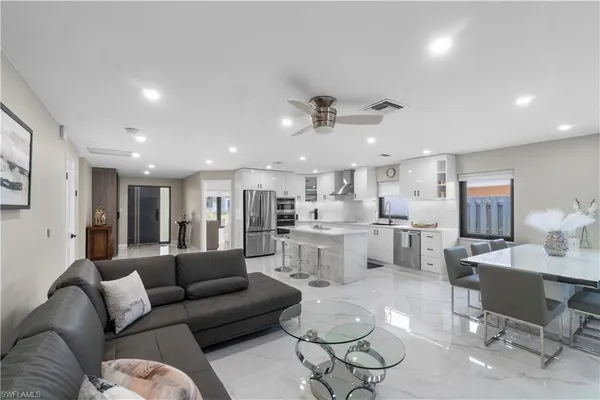 a view of a living room kitchen and a wooden floor