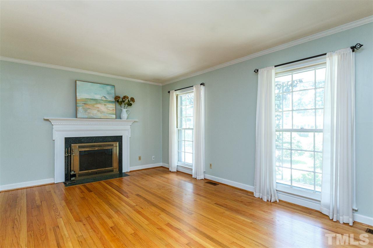 2108 Myron Drive Raleigh, NC 27607 - Photo 4 of 30 Bright and sizeable Living Area with centerpiece fireplace and flowing hardwood flooring.