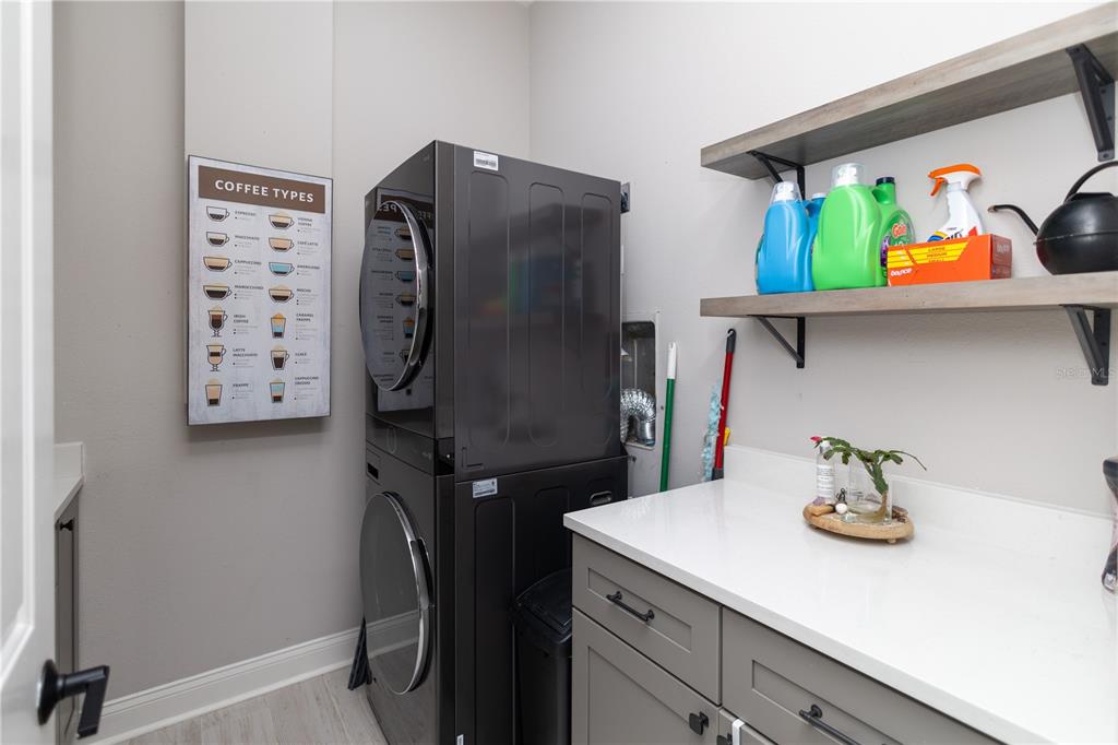 3305 Schoolhouse Road St. Cloud, FL 34773 - Photo 23 of 83 a kitchen with a refrigerator and a stove