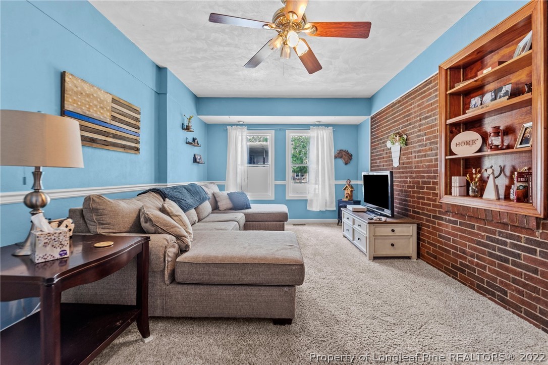 1103 Vass Road Spring Lake, NC 28390 - Photo 25 of 37 a living room with furniture and a flat screen tv