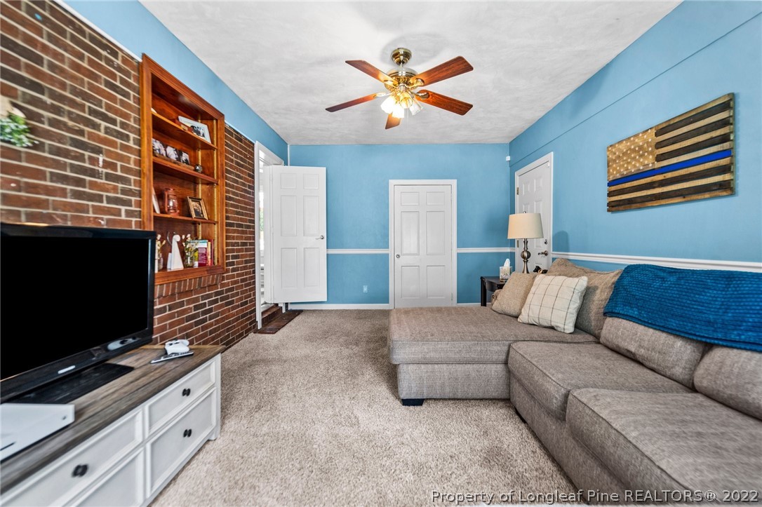 1103 Vass Road Spring Lake, NC 28390 - Photo 27 of 37 a living room with furniture and a flat screen tv
