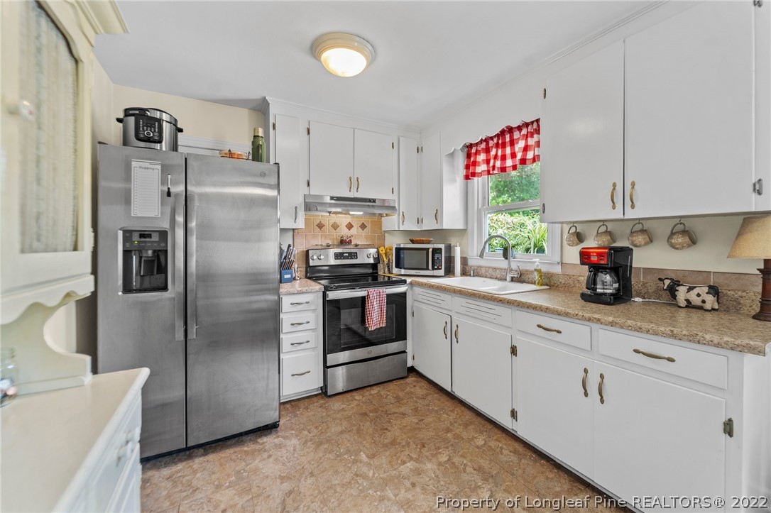 1103 Vass Road Spring Lake, NC 28390 - Photo 33 of 37 a kitchen with cabinets and stainless steel appliances