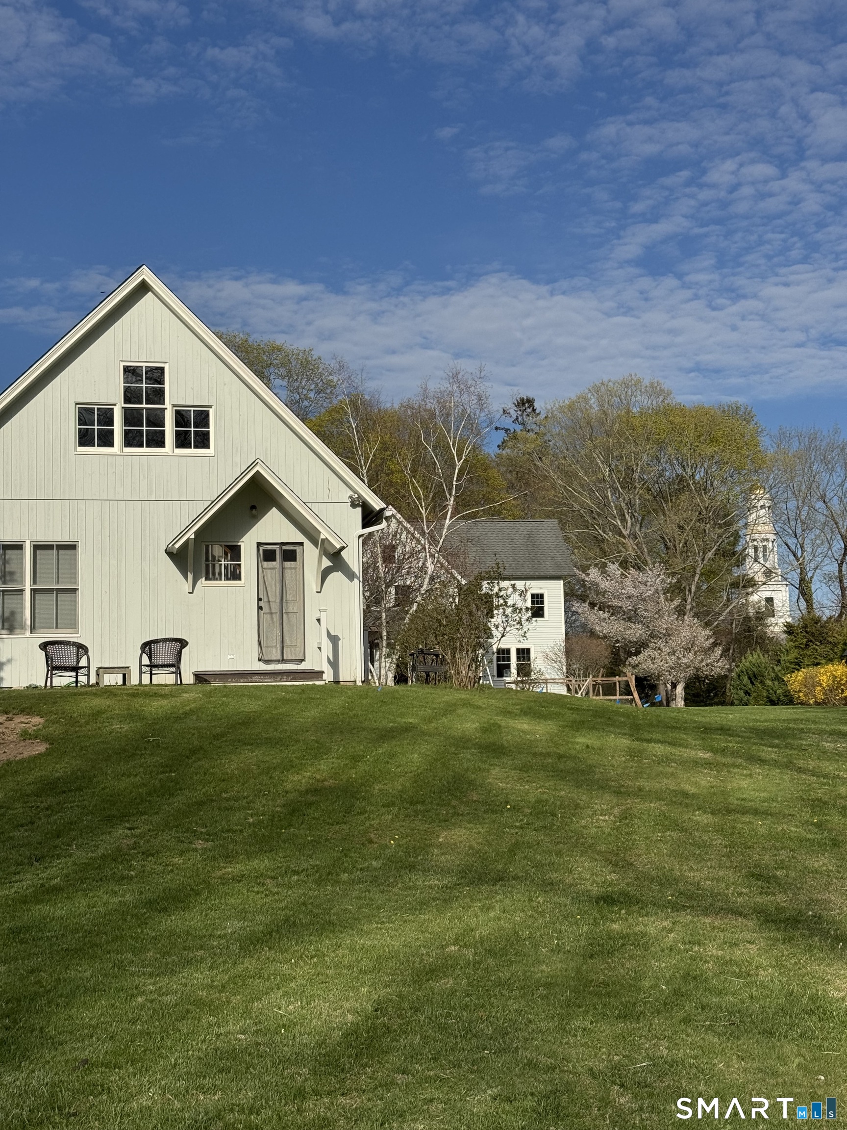 33 Copse Road, Unit B Madison, CT 06443 - Photo 2 of 16 a front view of house with yard and green space