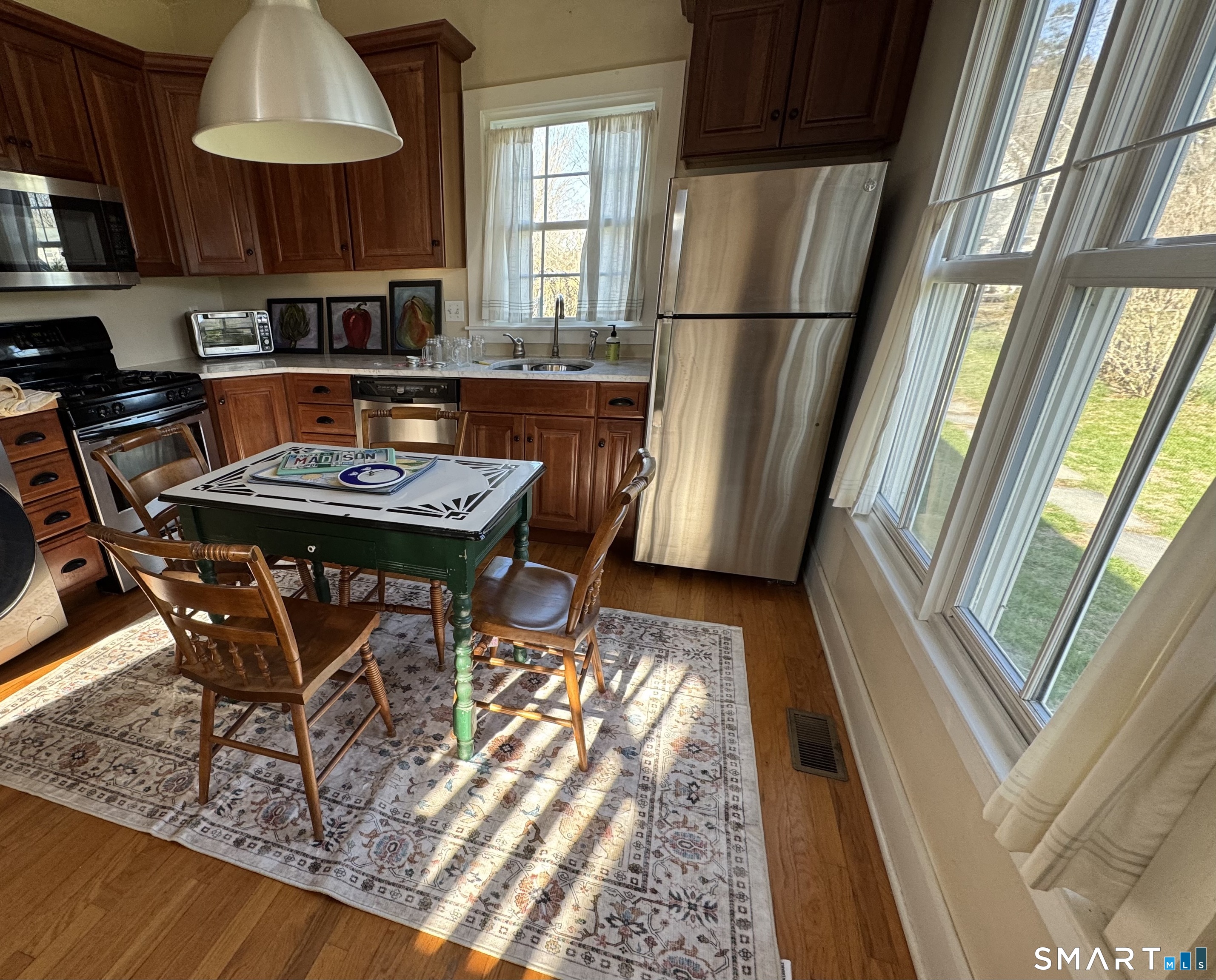 33 Copse Road, Unit B Madison, CT 06443 - Photo 4 of 16 a kitchen with stainless steel appliances granite countertop a sink refrigerator and microwave