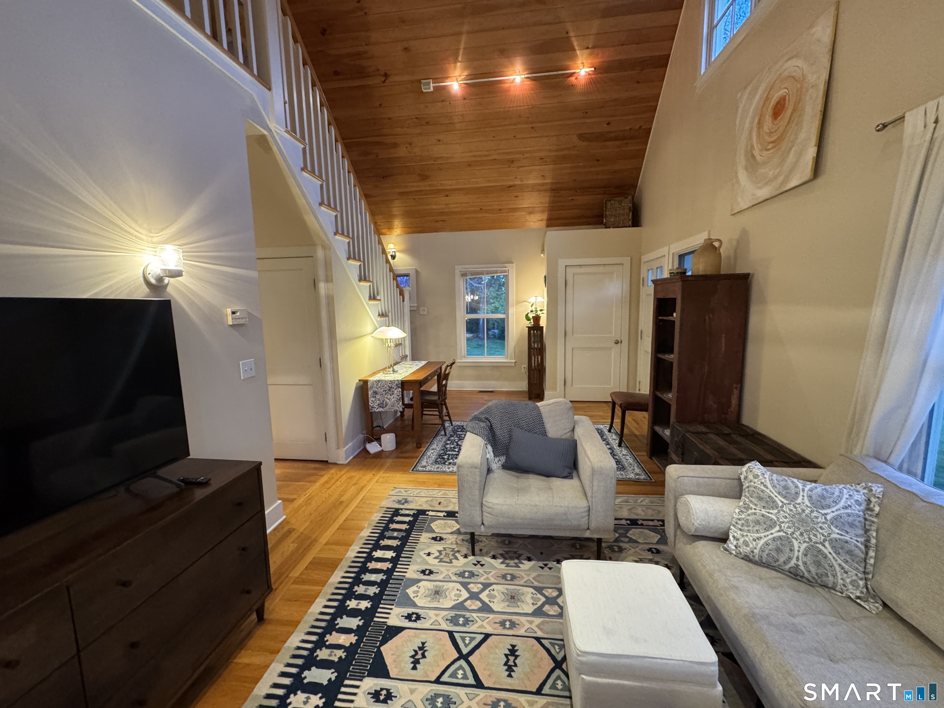 33 Copse Road, Unit B Madison, CT 06443 - Photo 6 of 16 a living room with furniture and a flat screen tv