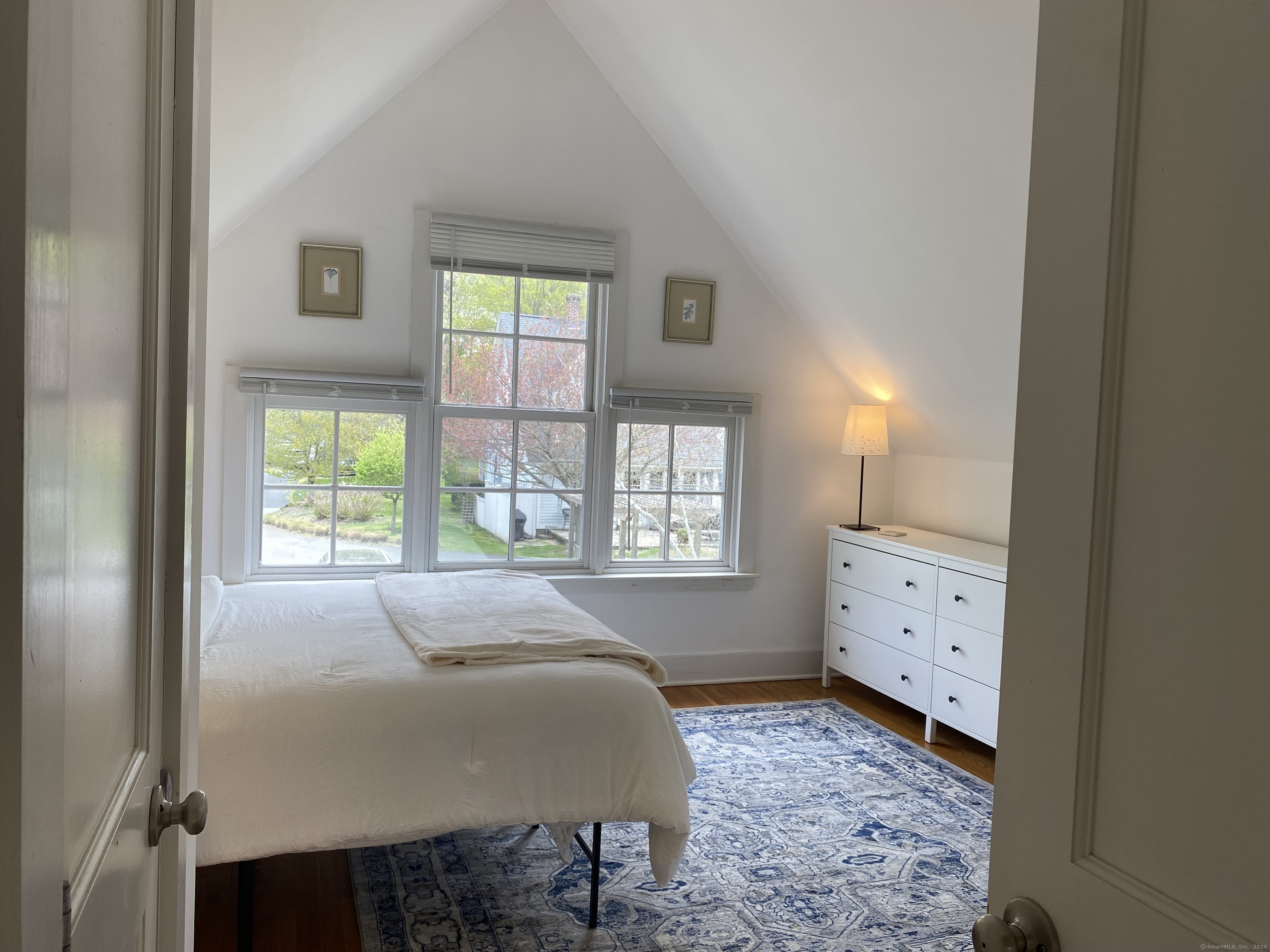 33 Copse Road, Unit B Madison, CT 06443 - Photo 8 of 16 a spacious bedroom with a bed and a window