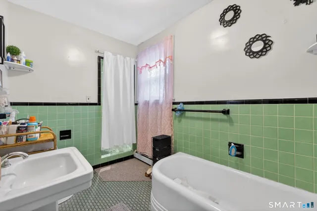 a bathroom with a sink mirror toilet and bathtub