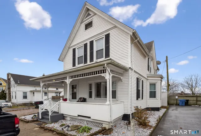 a front view of a house with parking area