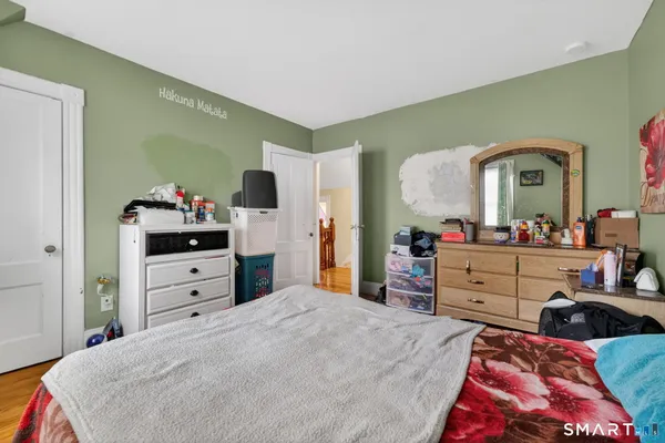 a bedroom with a bed and a dresser