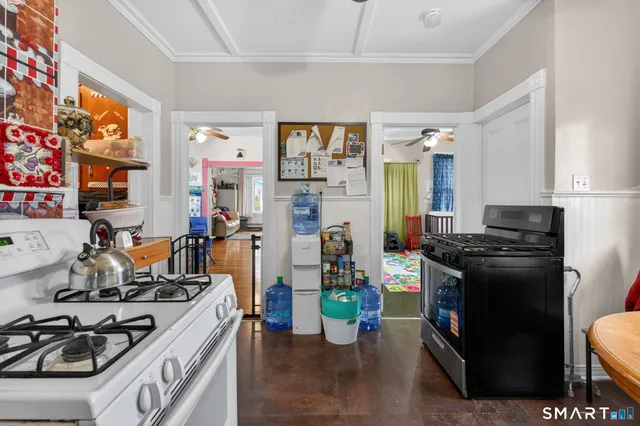 a kitchen with stainless steel appliances kitchen island granite countertop a stove and a sink