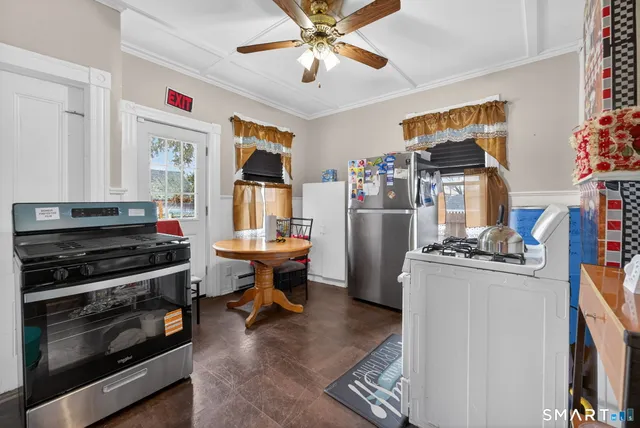a kitchen with stainless steel appliances a stove a refrigerator and a refrigerator