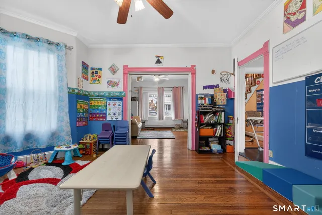 a living room with furniture and wooden floor