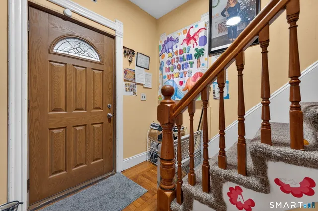 a view of an entryway with wooden floor