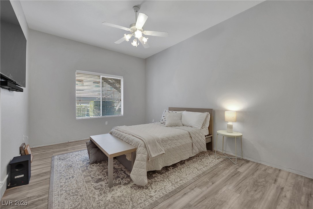 3544 Desert Cliff Street, Unit 101 Las Vegas, NV 89129 - Photo 5 of 29 Bedroom with a ceiling fan and light wood finished floors