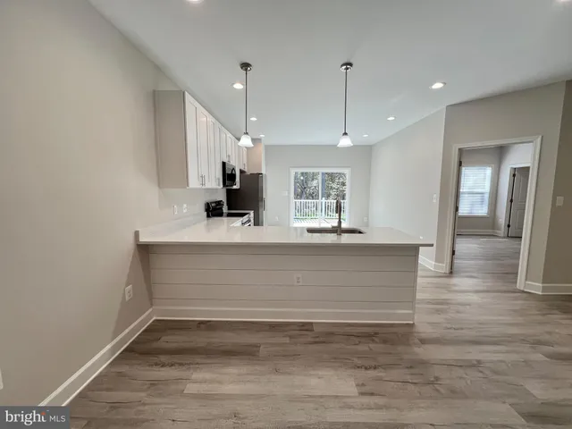 a spacious bathroom with a double vanity sink a large mirror and a