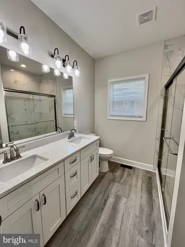 a view of a lake with a floor to ceiling window and wooden floor