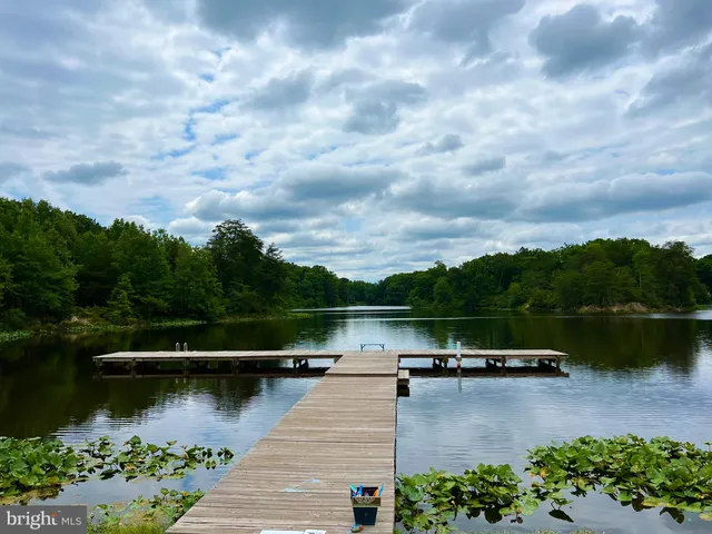 a view of a lake with houses in the back