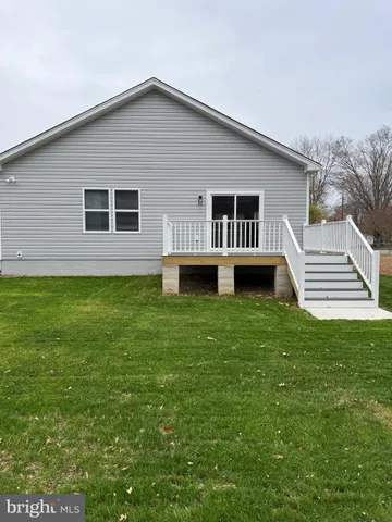 a view of a kitchen with wooden floor and a kitchen