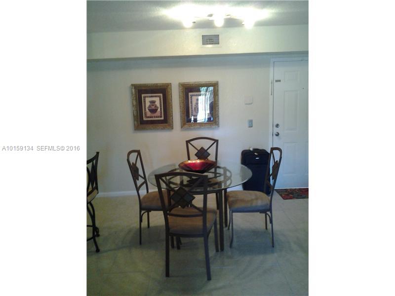 15480 Southwest 284th Street, Unit 2207 Homestead, FL 33033 - Photo 5 of 12 a view of a dining room with furniture and a potted plant