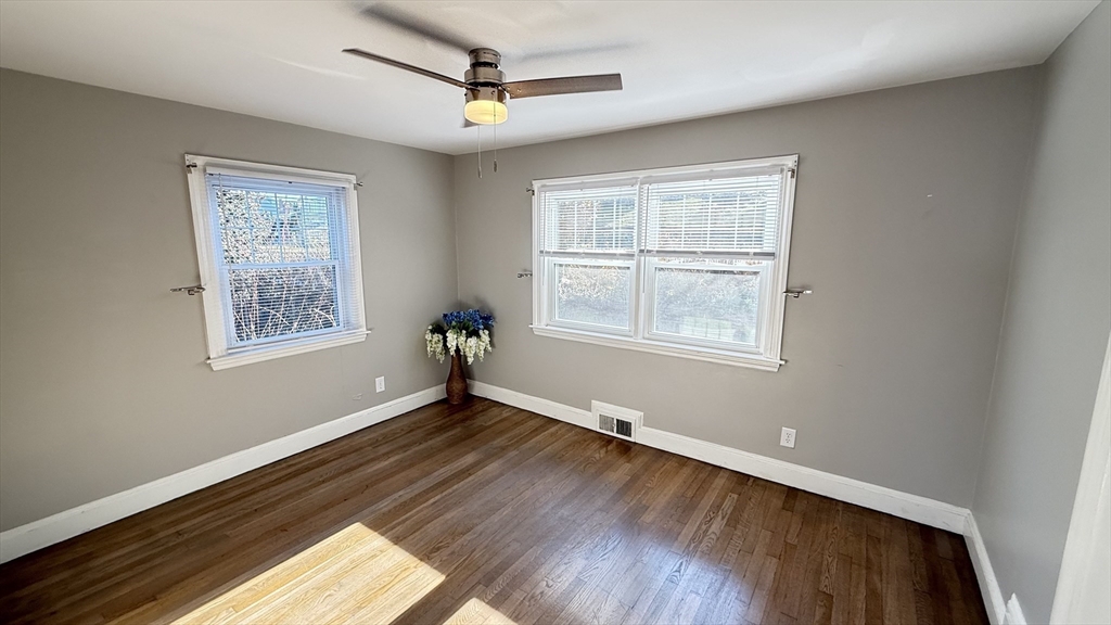 85 Regatta Road Weymouth, MA 02191 - Photo 13 of 33 a view of an empty room with wooden floor and a window