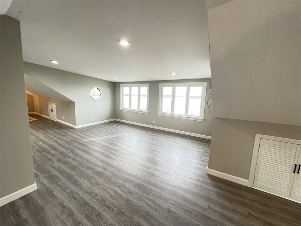 85 Regatta Road Weymouth, MA 02191 - Photo 19 of 33 an empty room with wooden floor and windows