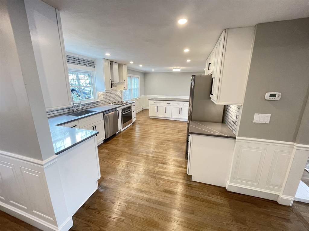 85 Regatta Road Weymouth, MA 02191 - Photo 7 of 33 a kitchen with stainless steel appliances granite countertop a refrigerator a sink and white cabinets