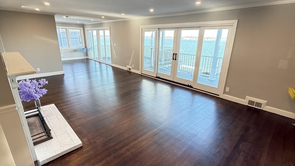 85 Regatta Road Weymouth, MA 02191 - Photo 8 of 33 a view of an empty room with wooden floor and a window