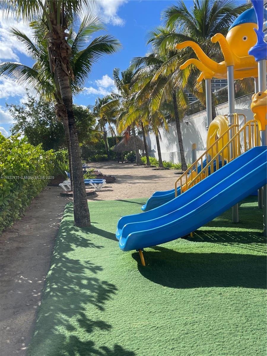 6039 Collins Avenue, Unit 823 Miami Beach, FL 33140 - Photo 16 of 21 a backyard of a house with lots of green space and fountain