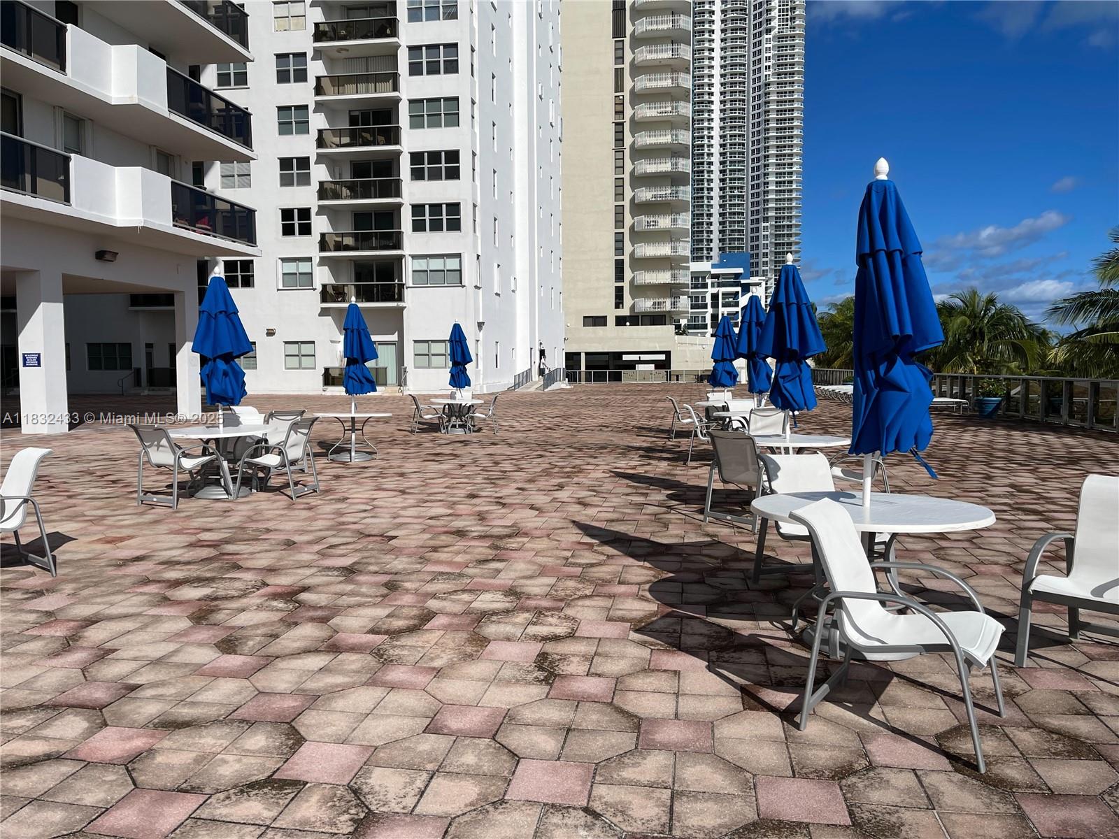 6039 Collins Avenue, Unit 823 Miami Beach, FL 33140 - Photo 17 of 21 a building outdoor space with patio furniture