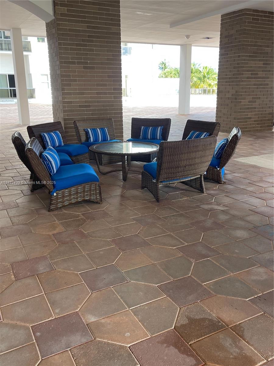 6039 Collins Avenue, Unit 823 Miami Beach, FL 33140 - Photo 18 of 21 a living room with patio furniture and a window