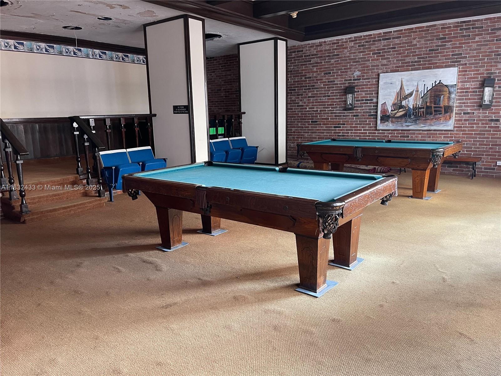 6039 Collins Avenue, Unit 823 Miami Beach, FL 33140 - Photo 19 of 21 a room with furniture pool table and wall paintings