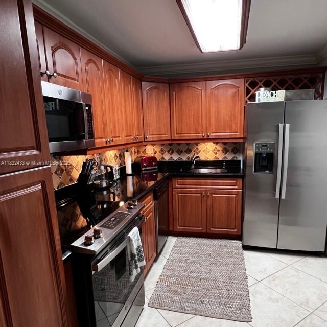 6039 Collins Avenue, Unit 823 Miami Beach, FL 33140 - Photo 3 of 21 a kitchen with granite countertop a stove a sink and a refrigerator