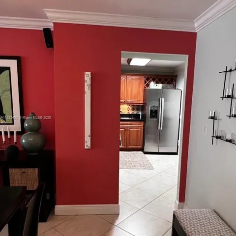 a view of kitchen with a refrigerator and a stove