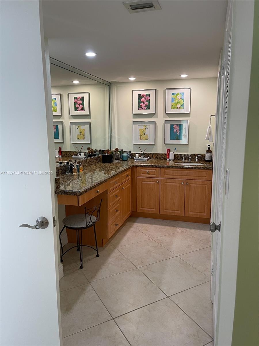 6039 Collins Avenue, Unit 823 Miami Beach, FL 33140 - Photo 9 of 21 a kitchen with stainless steel appliances granite countertop a sink and a refrigerator