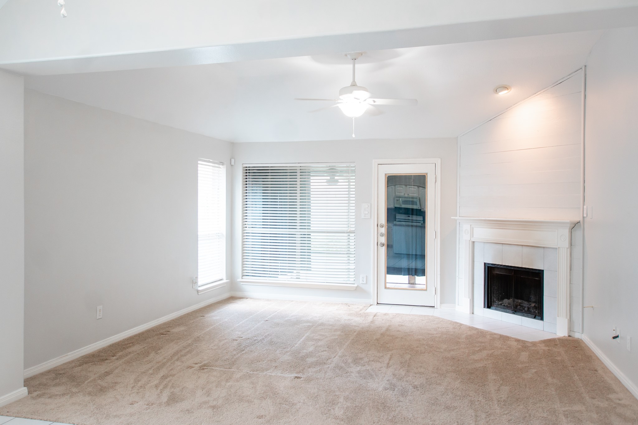1722 Red Oak Terrace Houston, TX 77339 - Photo 4 of 22 an empty room with a fireplace and fan