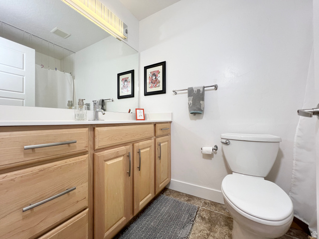 1017 South 275 West Logan, UT 84321 - Photo 20 of 36 Full bath with vanity, curtained shower, and dark stone finish floors