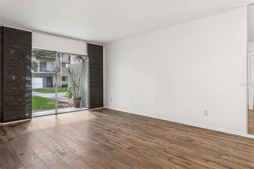 4606 West Gray Street, Unit 105 Tampa, FL 33609 - Photo 12 of 25 an empty room with wooden floor and a fireplace