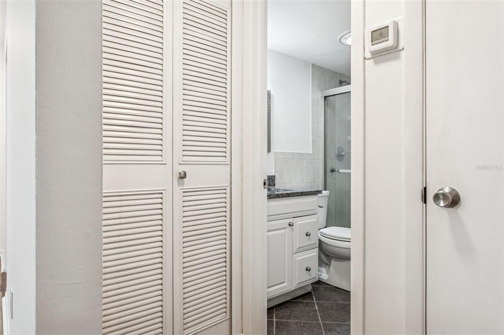 4606 West Gray Street, Unit 105 Tampa, FL 33609 - Photo 13 of 25 a bathroom with a granite countertop toilet and a sink