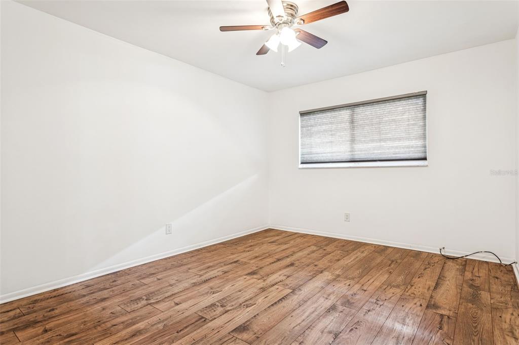 4606 West Gray Street, Unit 105 Tampa, FL 33609 - Photo 16 of 25 a view of a big room with wooden floor and closet in a room
