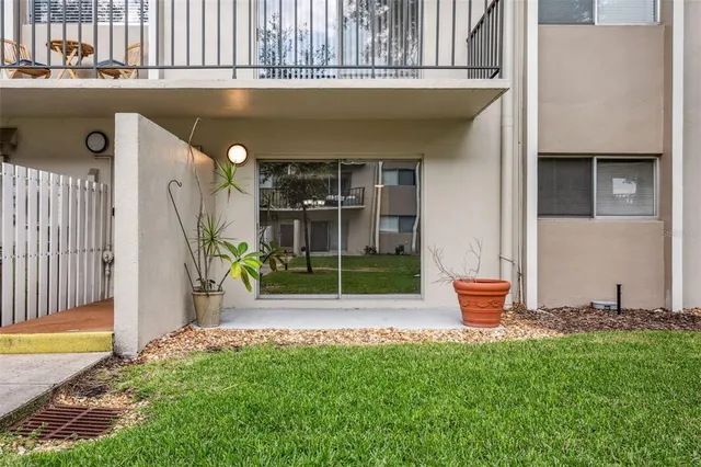 a outdoor view with a chair and potted plants