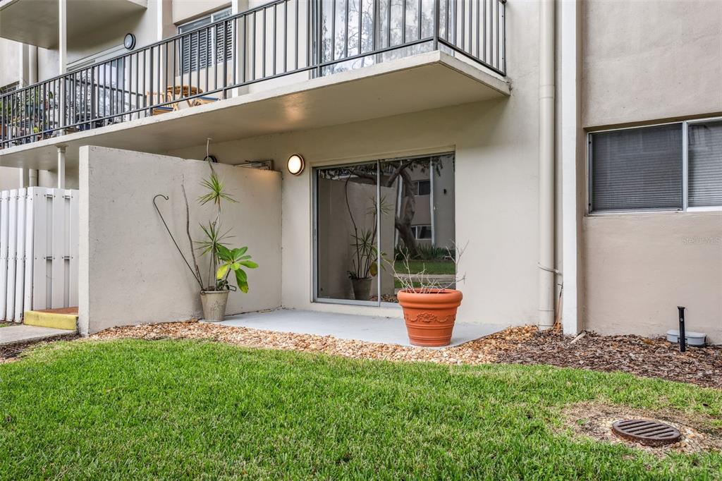4606 West Gray Street, Unit 105 Tampa, FL 33609 - Photo 21 of 25 a outdoor view with a chair and potted plants