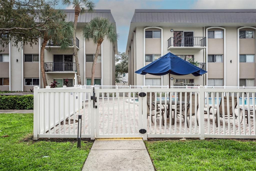 4606 West Gray Street, Unit 105 Tampa, FL 33609 - Photo 24 of 25 a front view of a house with a yard