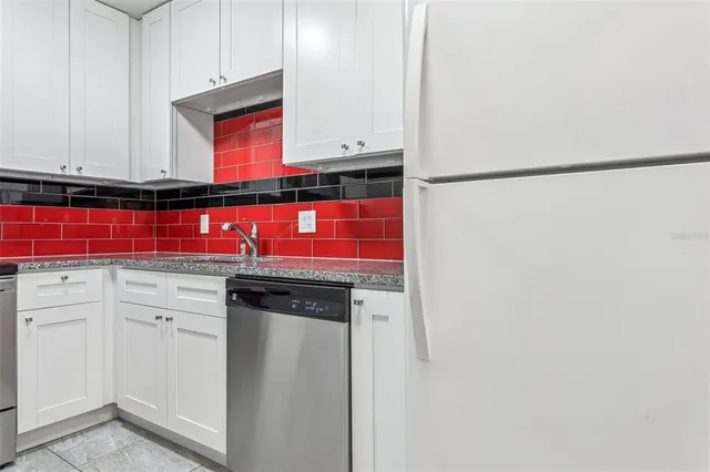 a view of a kitchen with refrigerator and cabinet