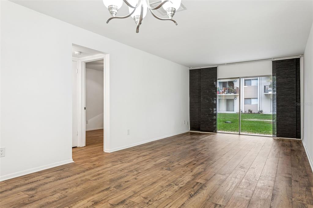 4606 West Gray Street, Unit 105 Tampa, FL 33609 - Photo 10 of 25 a view of an empty room with wooden floor and a window