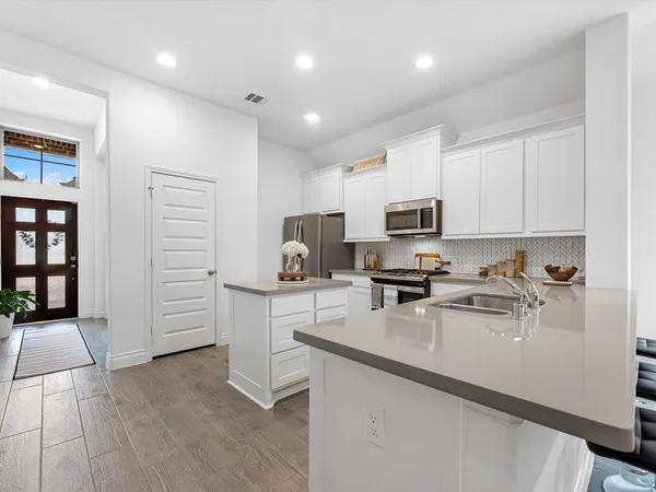 a view of an house with backyard space and balcony