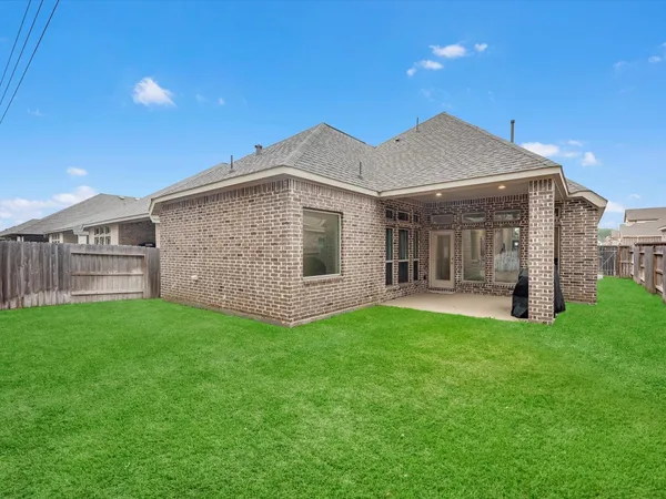 a view of an house with backyard space and balcony