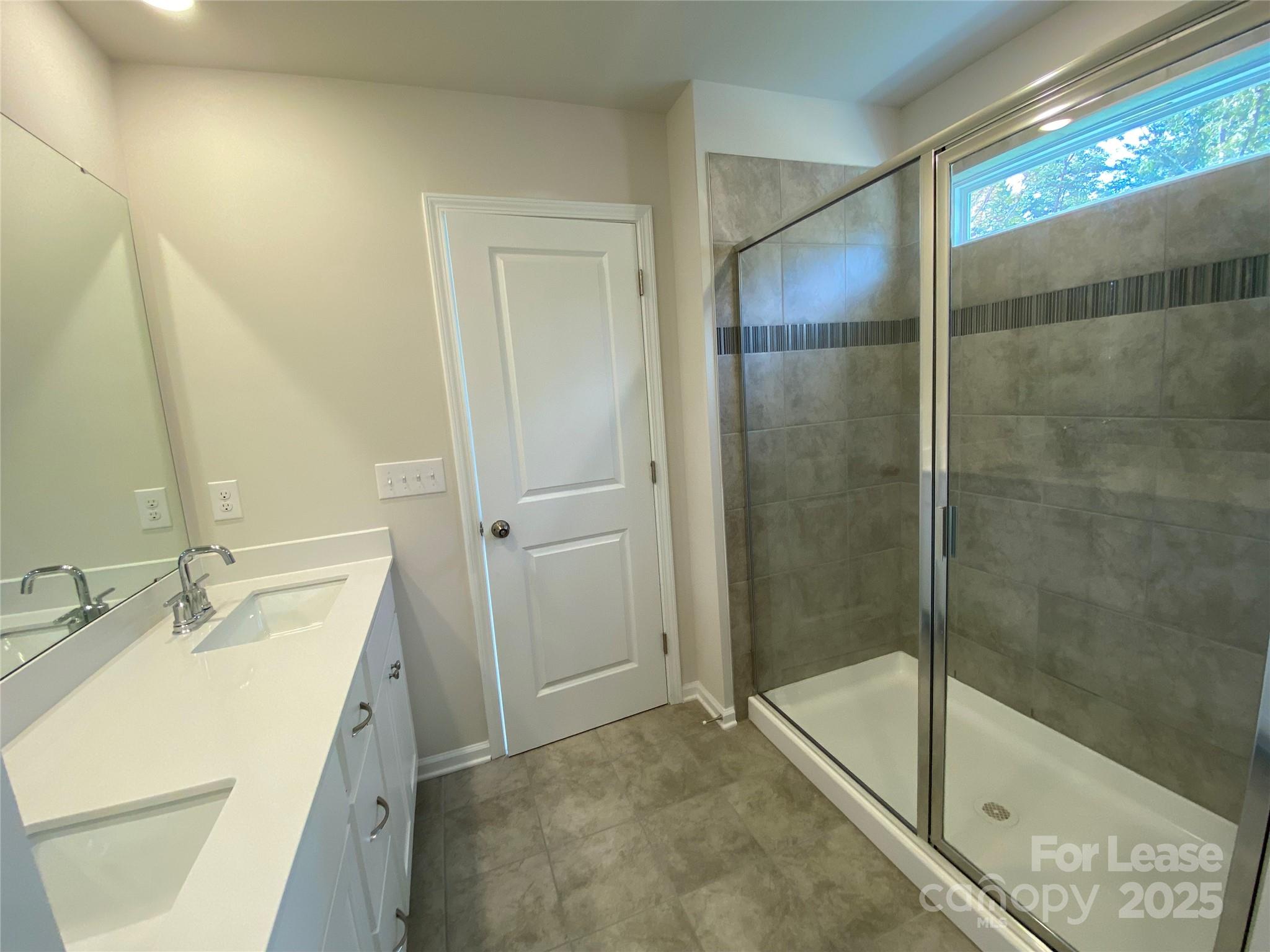 18219 Stark Way Charlotte, NC 28278 - Photo 21 of 42 a bathroom with a shower sink and mirror