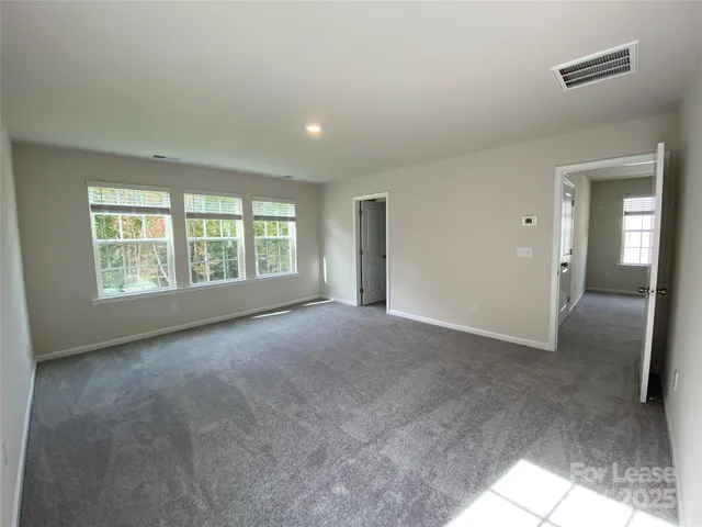 a spacious bathroom with a double vanity sink a mirror and a shower