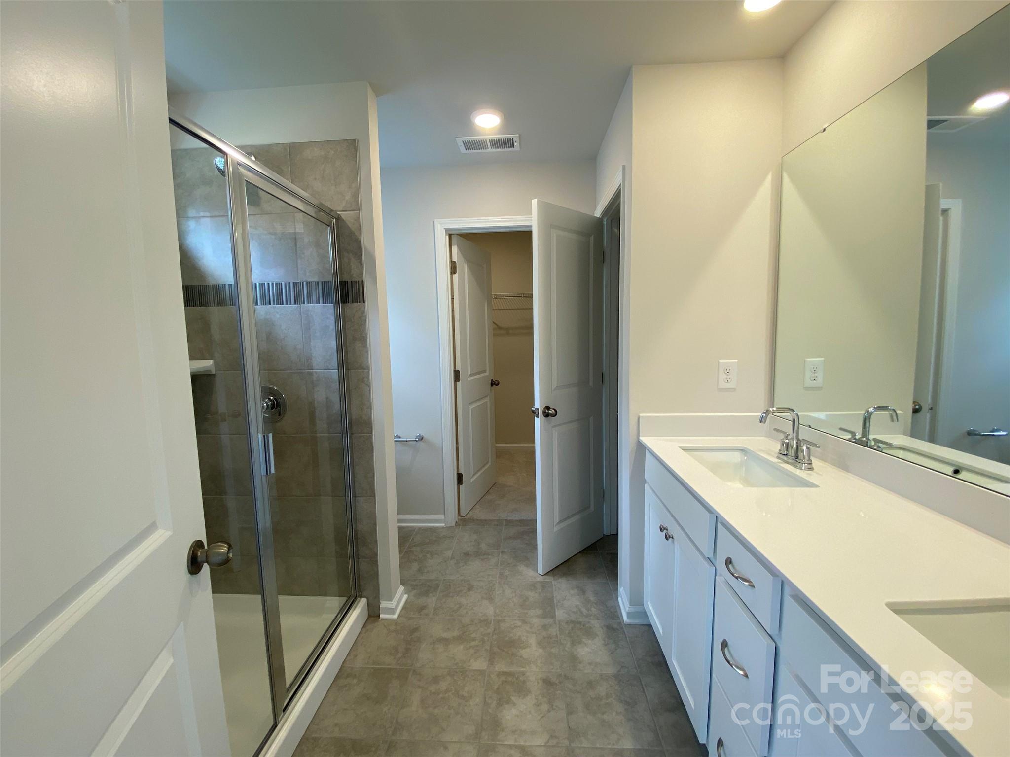 18219 Stark Way Charlotte, NC 28278 - Photo 26 of 42 a bathroom with a double vanity sink mirror and shower